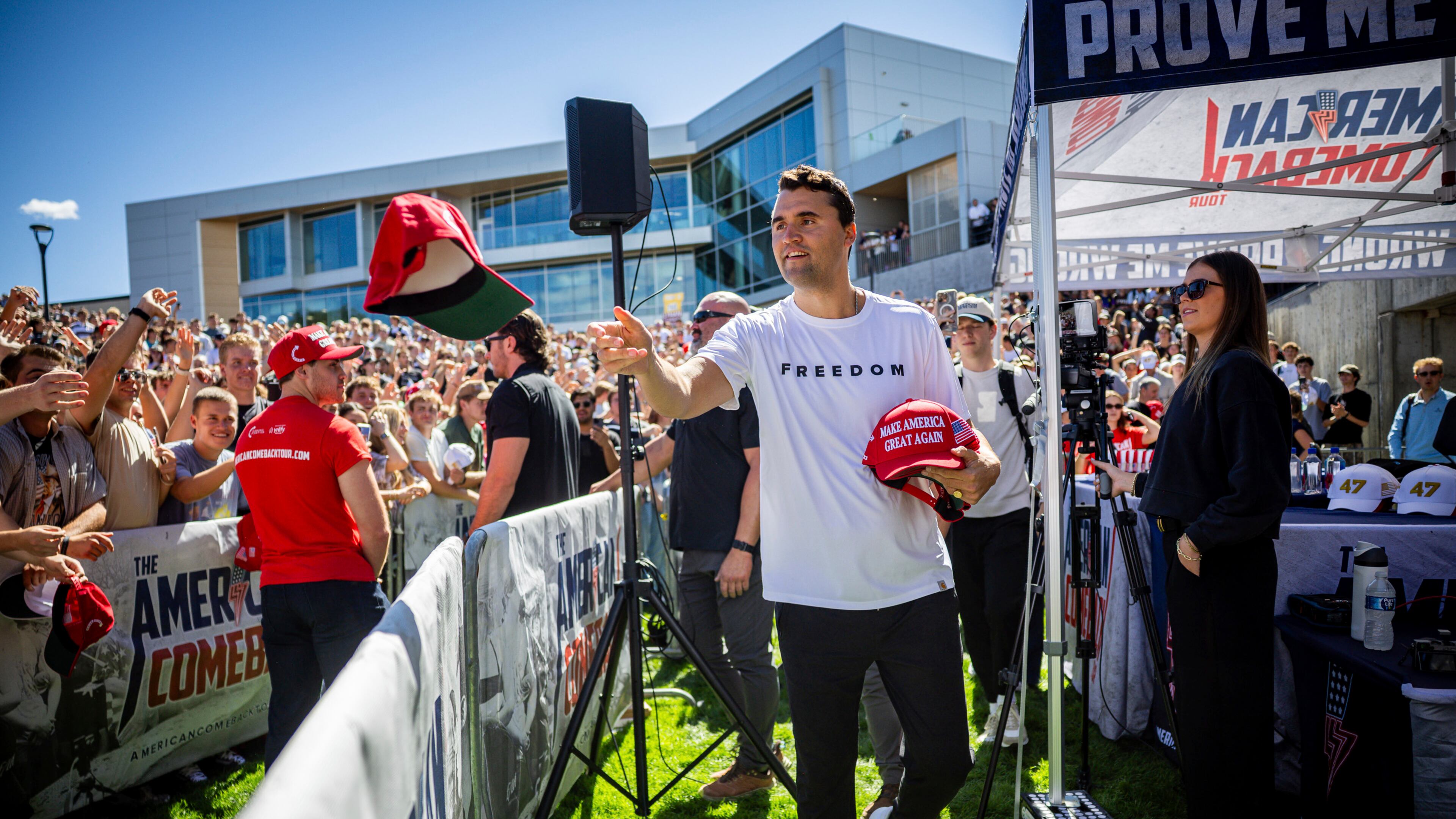 Charlie Kirk hands out hats before speaking at Utah Valley University in Orem, Utah, Wednesday, Sept. 10, 2025. (Tess Crowley/The Deseret News via AP)