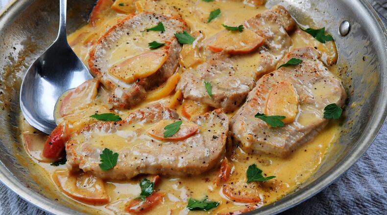 Pork Chops with Apples and Cream Sauce. (Chris Hunt for The Atlanta Journal-Constitution)