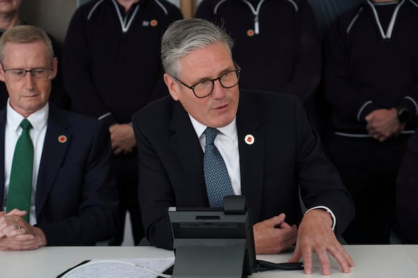 Britain's Prime Minister Keir Starmer speaks on the phone to US President Donald Trump at a car factory in the West Midlands, Thursday, May 8, 2025.(AP Photo/Alberto Pezzali, Pool)