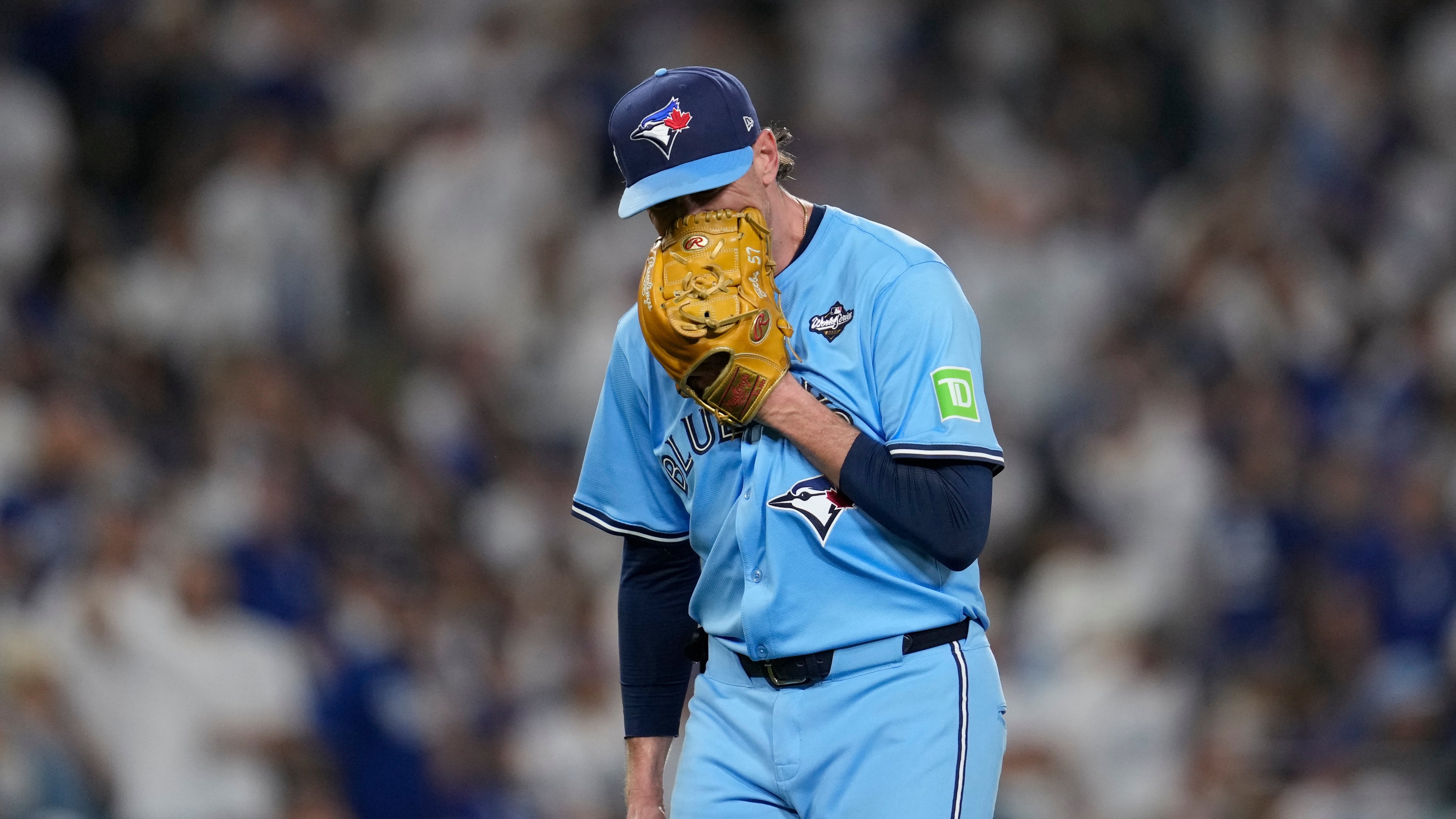 Toronto Blue Jays' pitcher Shane Bieber yells in his glove as he leaves the game during the sixth inning in Game 4 of baseball's World Series against the Los Angeles Dodgers, Tuesday, Oct. 28, 2025, in Los Angeles. (AP Photo/Ashley Landis)