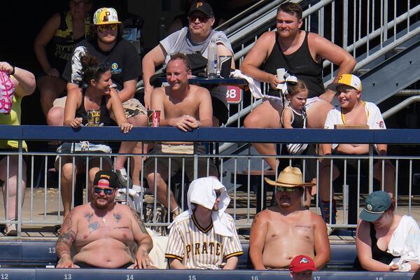 Extreme heat warnings didn't keep these fans from attending a baseball game between the Pittsburgh Pirates and the Texas Rangers in Pittsburgh, Sunday, June 22, 2025. (AP Photo/Gene J. Puskar)