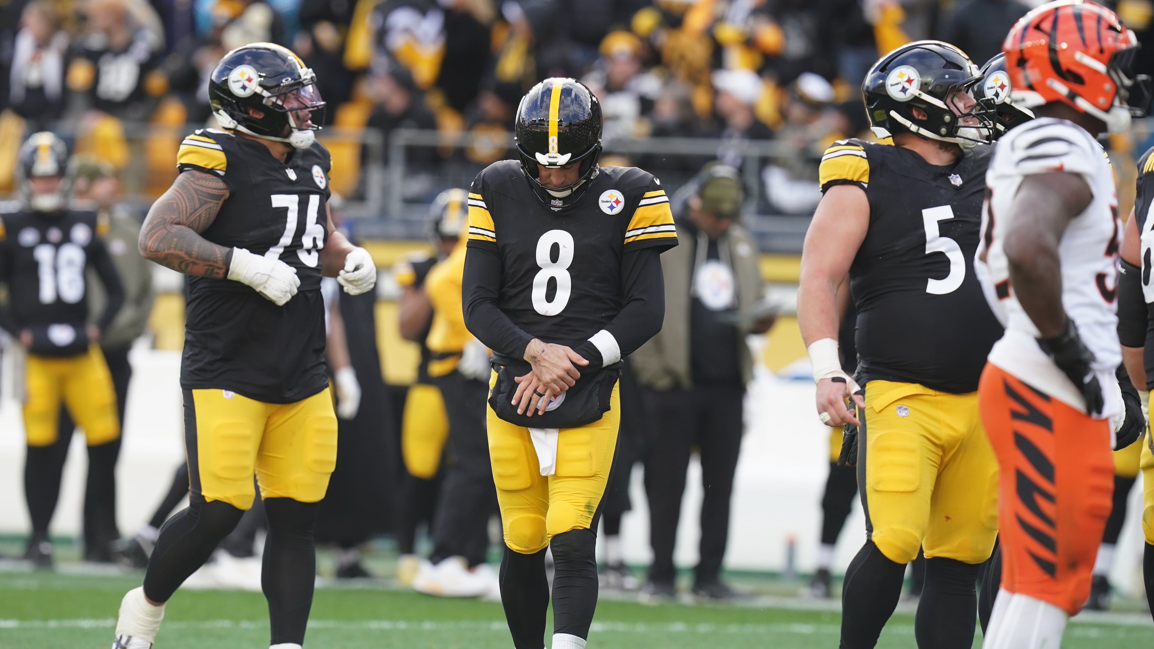 Pittsburgh Steelers quarterback Aaron Rodgers (8) holds his arm after a hit by the Cincinnati Bengals during the first half of an NFL football game Sunday, Nov. 16, 2025, in Pittsburgh. (AP Photo/Matt Freed)