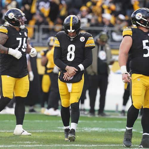 Pittsburgh Steelers quarterback Aaron Rodgers (8) holds his arm after a hit by the Cincinnati Bengals during the first half of an NFL football game Sunday, Nov. 16, 2025, in Pittsburgh. (AP Photo/Matt Freed)