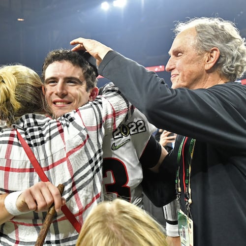 Georgia's quarterback Stetson Bennett (13) celebrates with his family after Georgia won 2022 College Football Playoff National Championship at Lucas Oil Stadium in Indianapolis on Monday, January 10, 2022. (Hyosub Shin / Hyosub.Shin@ajc.com)