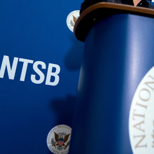 FILE - The National Transportation Safety Board logo and signage are seen at a news conference at NTSB headquarters in Washington, Dec. 18, 2017. (AP Photo/Andrew Harnik, File)