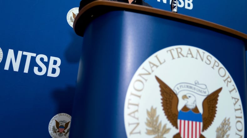 FILE - The National Transportation Safety Board logo and signage are seen at a news conference at NTSB headquarters in Washington, Dec. 18, 2017. (AP Photo/Andrew Harnik, File)