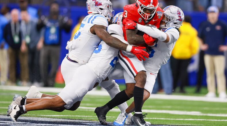 Georgia Bulldogs running back Nate Frazier runs for a first down against the Ole Miss Rebels defense during the fourth quarter of the NCAA College Football Playoff quarterfinal game at the Sugar Bowl in the Caesars Superdome, Thursday, Jan. 1, 2026, in New Orleans. (Jason Getz/AJC)
