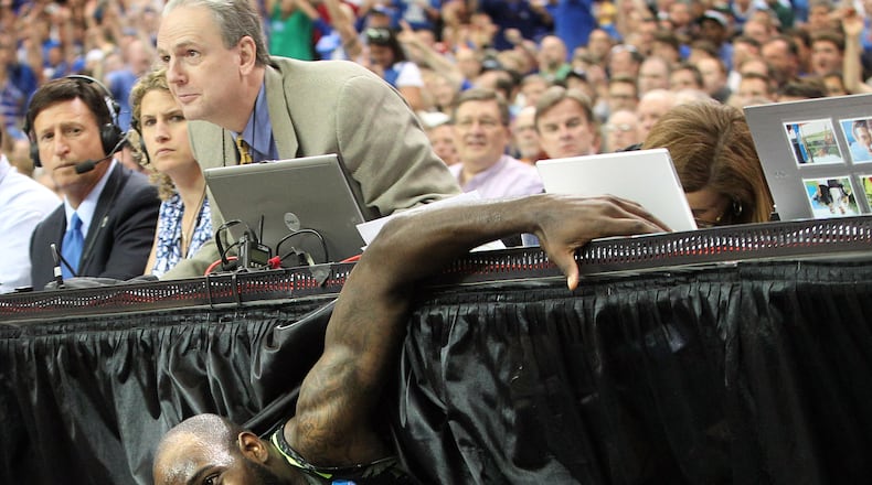 The AJC's Mark Bradley watches as Baylor forward Quincy Acy crashes into the press table chasing a lose ball against Kentucky in the NCAA South Regional at the Georgia Dome, Atlanta, Sunday, March 25, 2012.