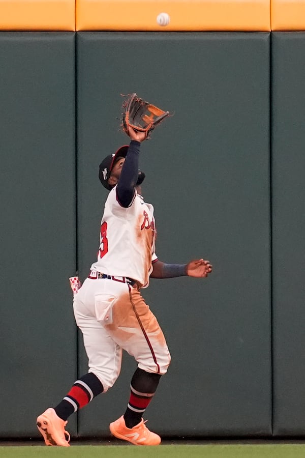 Atlanta Braves outfielder Michael Harris II (23) makes the catch for the out against Los Angeles Dodgers two-way player Shohei Ohtani (17) in the fifth inning of a baseball game, Sunday, May 4, 2025, in Atlanta. (AP Photo/Mike Stewart)