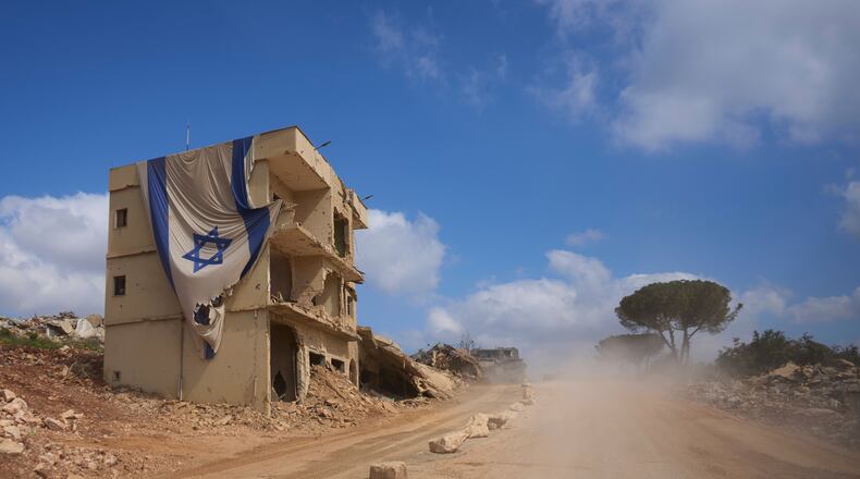 An Israeli flag hangs from a building in an area occupied by Israeli troops in southern Lebanon, Thursday, July 9, 2026. The Israeli military invited reporters on a tour of the strategic mountain topped by the Crusader-built Beaufort Castle months after launching a ground invasion that captured dozens of Lebanese villages and towns in southern Lebanon. (AP Photo/Ohad Zwigenberg)