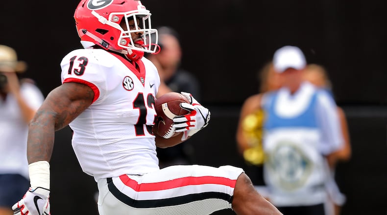 October 7, 2017 Nashville: Georgia tailback Elijah Holyfield high steps into the endzone against Vanderbilt for a touchdown to take a 45-7 lead during the fourth quarter in a NCAA college football game on Saturday, October 7, 2017, in Nashville.   Curtis Compton/ccompton@ajc.com
