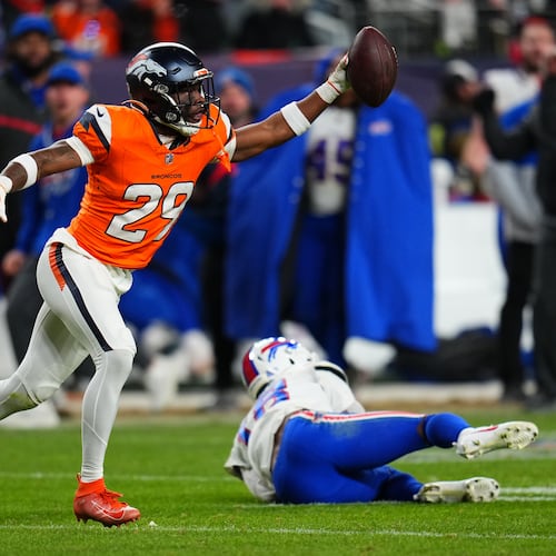 Denver Broncos cornerback Ja'quan McMillian (29) reacts after intercepting a pass intended for Buffalo Bills wide receiver Brandin Cooks (18) during overtime of an NFL divisional round playoff football game, Saturday, Jan. 17, 2026, in Denver. (AP Photo/Jack Dempsey)