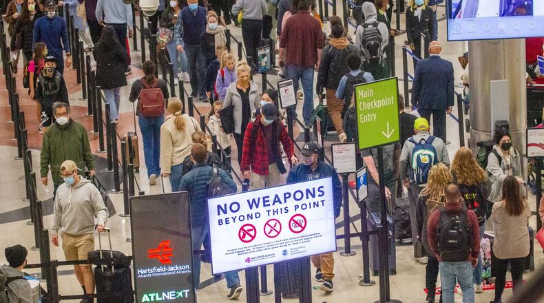 A gun went off Saturday, Nov. 20, 2021, in Hartsfield-Jackson International Airport, panicking travelers and delaying flights. On Sunday, travelers were reminded of the safety precautions with “No Weapons Beyond This Point” signage. The airport was filled with long lines snaking their way to the security checkpoints.