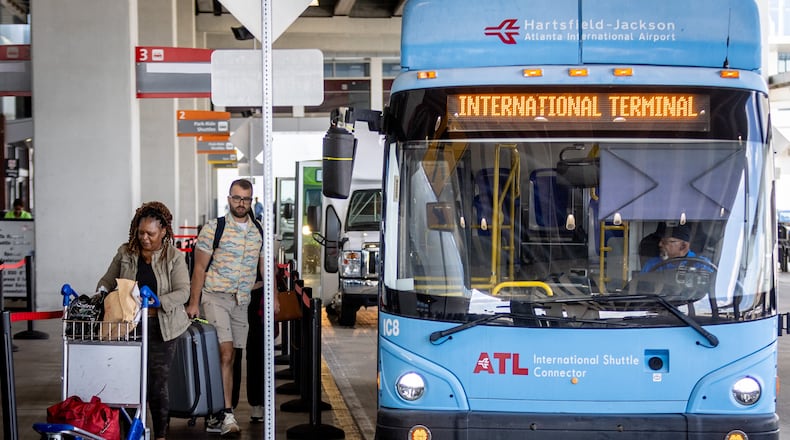 Passengers board the terminal-to-terminal shuttle at the international terminal on Tuesday, Sept. 29, 2023.  (Steve Schaefer/steve.schaefer@ajc.com)