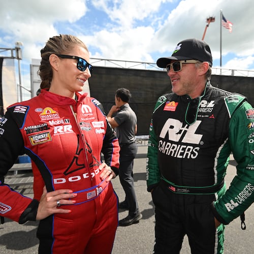 Married NHRA drivers Leah Pruett, left, and Tony Stewart chat pre-race at New England Dragway in Epping, NH, Sunday, June 7, 2026, for the NHRA New England Nationals. (Marc Gewertz/NHRA via AP)