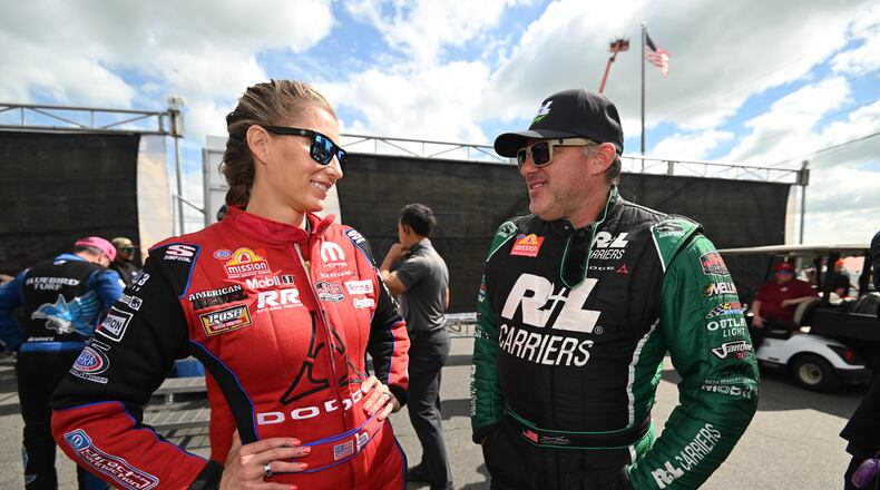 Married NHRA drivers Leah Pruett, left, and Tony Stewart chat pre-race at New England Dragway in Epping, NH, Sunday, June 7, 2026, for the NHRA New England Nationals. (Marc Gewertz/NHRA via AP)