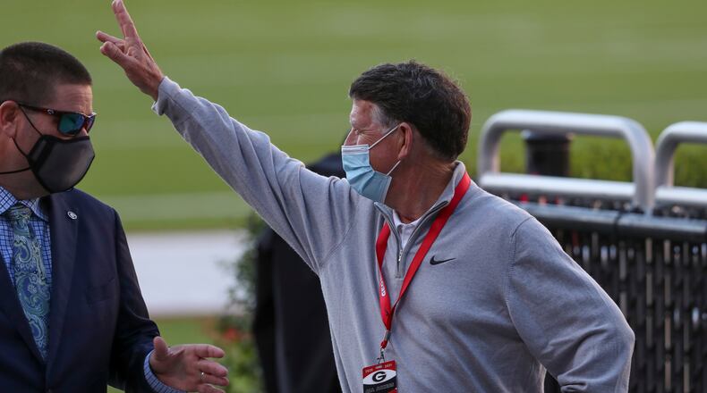Georgia director of athletics Greg McGarity waves to fans entering Sanford Stadium prior to Saturday's game against Auburn.