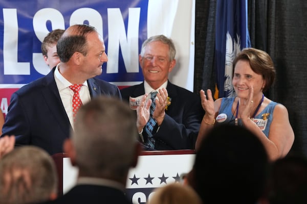 South Carolina Attorney General Alan Wilson, left, speaks at his launch event for the state's 2026 governor's race as his father, Rep. Joe Wilson, R-S.C., and mother, Roxanne Wilson, watch, Monday, June 23, 2025, in Lexington, S.C. (AP Photo/Meg Kinnard)
