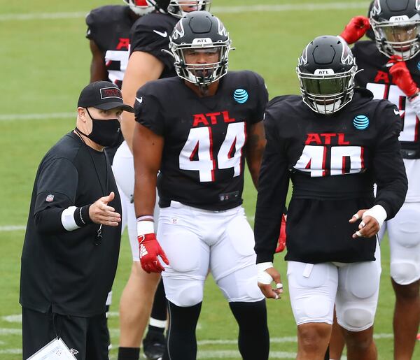 Falcons coach Dan Quinn works with (from left) fullbacks Mikey Daniel and Keith Smith during the second scrimmage Monday, August 24, 2020 in Flowery Branch.  Curtis Compton ccompton@ajc.com 
