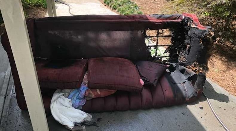 A woman might have been smoking on her couch when a fire overwhelmed her, but a neighbor smashed her sliding glass door wish a rock and dragged her from the flames on Friday, July 20, 2018, said Cobb County fire authorities.
