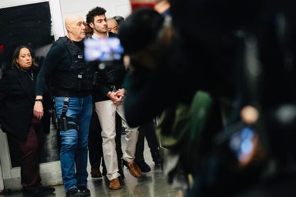 FILE - Luigi Mangione, accused of fatally shooting Brian Thompson, the CEO of UnitedHealthcare, is escorted to Manhattan state court in New York, Friday, Feb. 21, 2025.(AP Photo/Stefan Jeremiah, File)