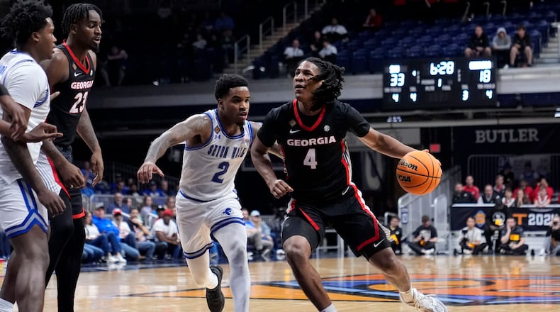 Georgia guard Silas Demary Jr. (4) drives past Seton Hall guard Al-Amir Dawes (2) in the first half of an NCAA college basketball game in the semifinals of the NIT, Tuesday, April 2, 2024, in Indianapolis. (AP Photo/Michael Conroy)
