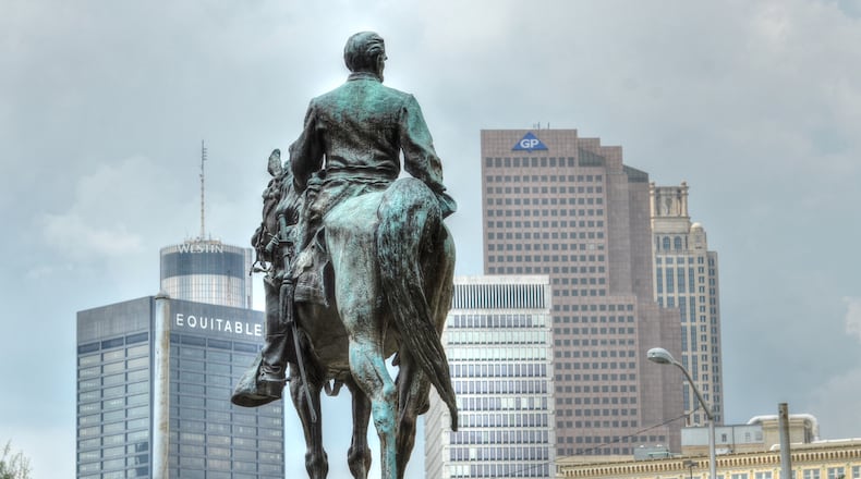 The statue of John Brown Gordon, U.S. senator, governor and Confederate general at the State Capitol, against the backdrop of downtown Atlanta. AJC/Chris Hunt