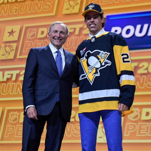 Liam Ruck, right, stands with NHL Commissioner Gary Bettman after being drafted by the Pittsburgh Penguins during the NHL hockey draft Friday, June 26, 2026, in Buffalo, N.Y. (AP Photo/Adrian Kraus)