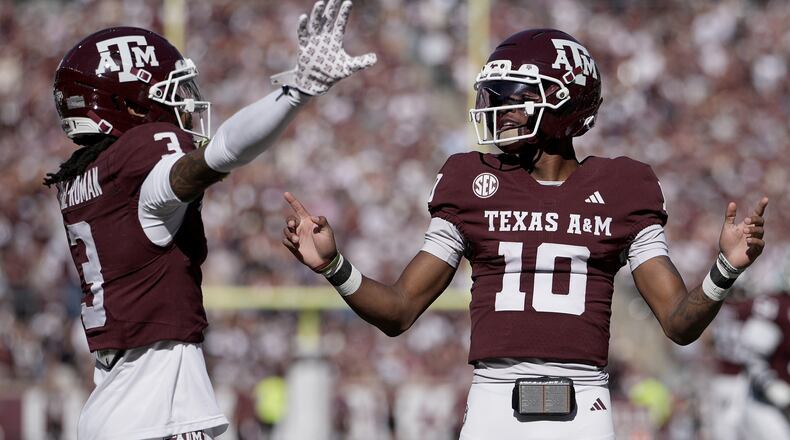 Texas A&M wide receiver Ashton Bethel-Roman (3) reacts with quarterback Marcel Reed (10) after scoring a touchdown agianst Samford during the first quarter of an NCAA college football game Saturday, Nov. 22, 2025, in College Station, Texas. (AP Photo/Sam Craft)