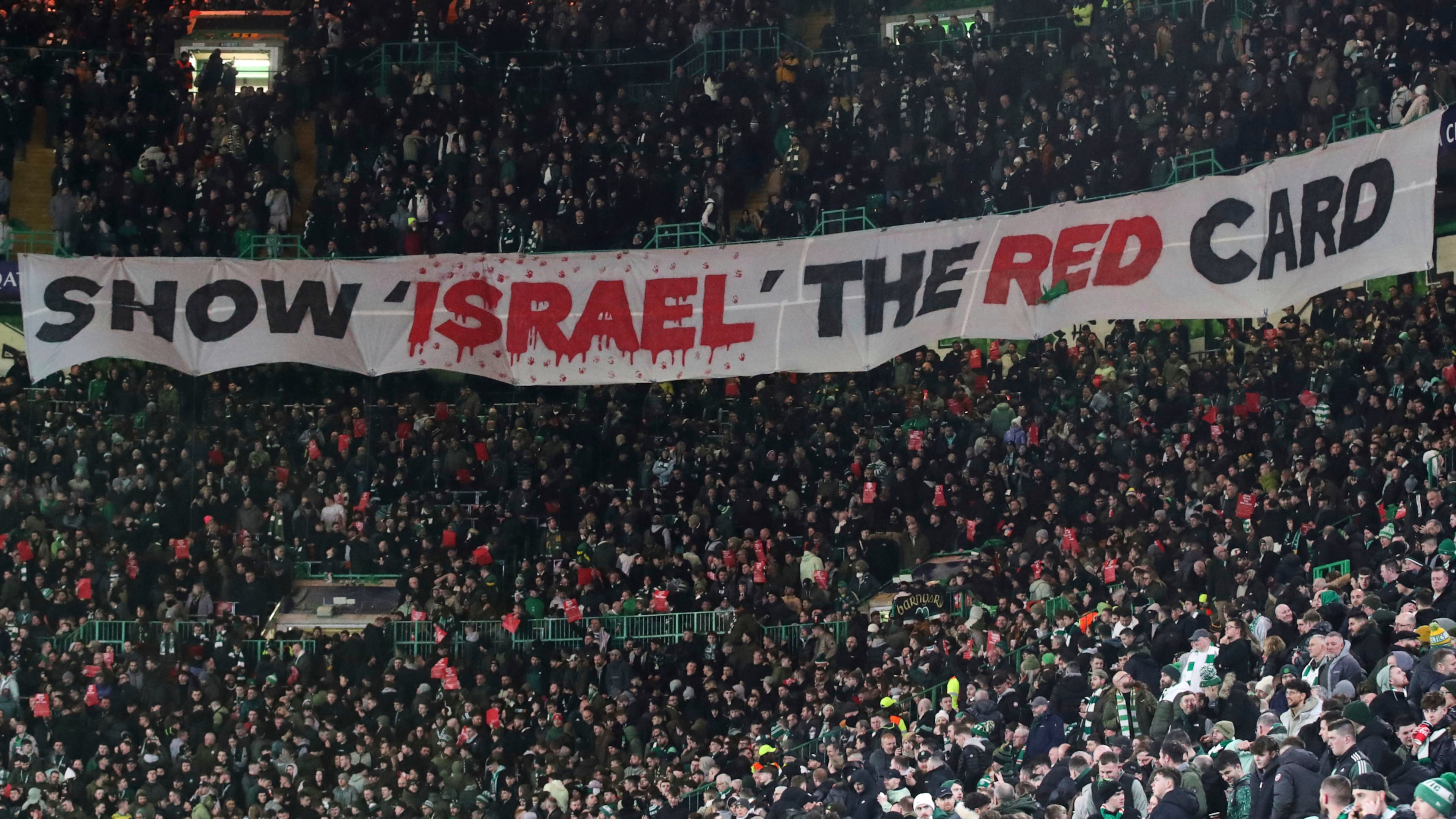 FILE - Celtic fans lift a protest banner about Israel during the Champions League playoff first leg soccer match between Glasgow Celtic and Bayern Munich at the Celtic Park Stadium in Glasgow, Scotland, Wednesday, Feb. 12, 2025. (AP Photo/Scott Heppell, File)