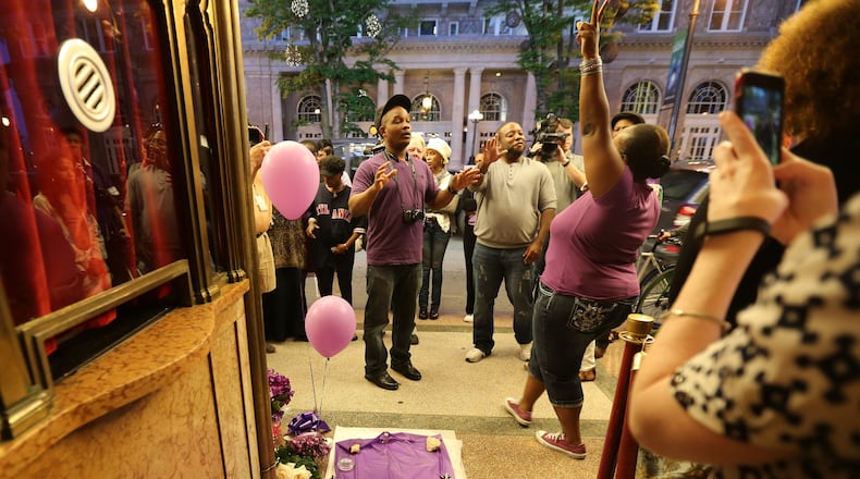 April 22, 2016 Atlanta: Yusuf Muhammad encourages fans to tell how Prince affected their lives during a vigil in front of the Fox Theatre on Friday night April 22, 2016. The musician played his final public concert at the Fox a week before he died. Ben Gray / bgray@ajc.com