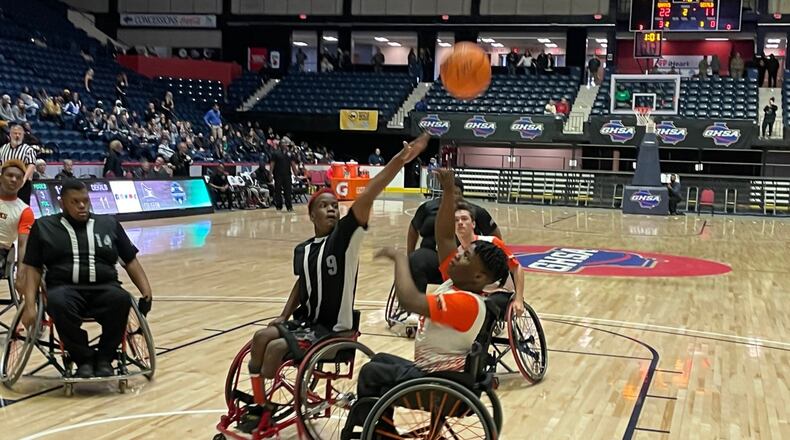 Houston County's Jaquavious West shoots over the outstretched arm of DeKalb's Najee Smothers in the second half of a 32-13 victory in the AAASP Wheelchair basketball championship game on Saturday, March 12, 2022, at the Macon Coliseum.