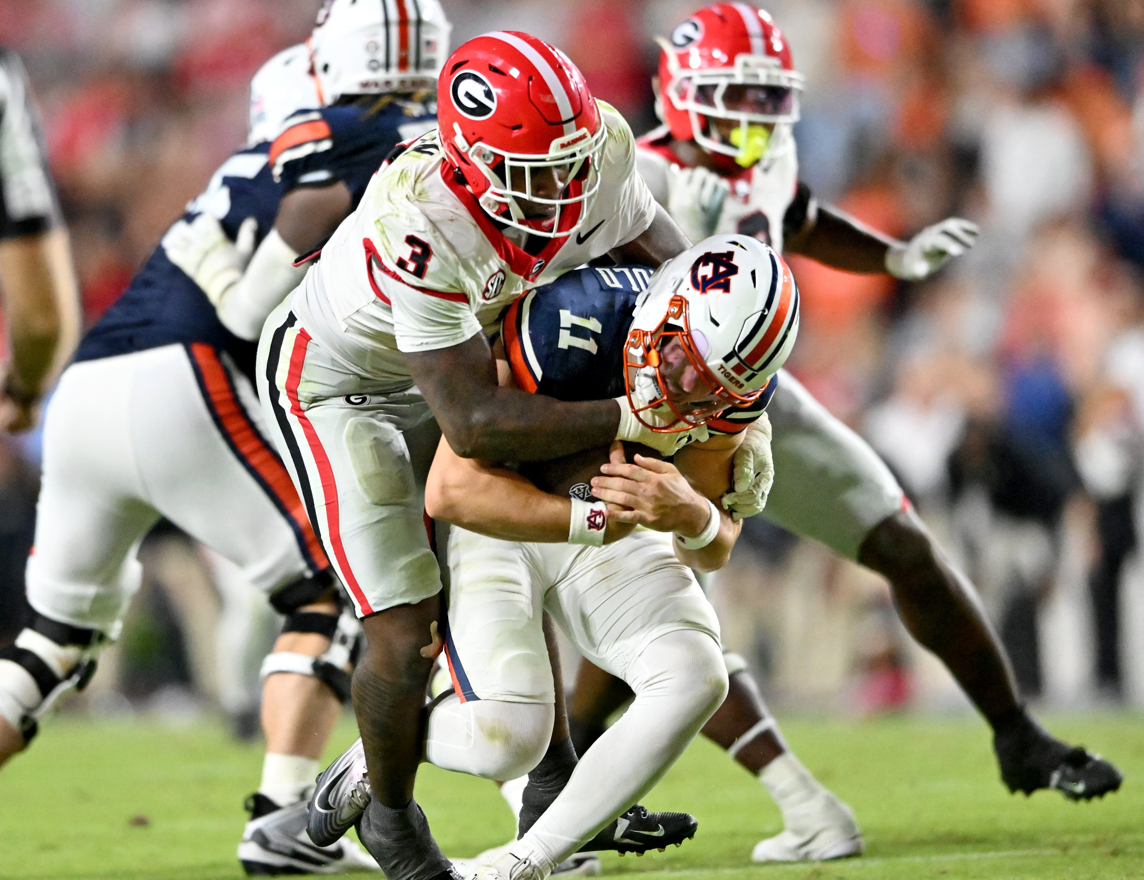 Auburn quarterback Jackson Arnold (11) is sacked by Georgia linebacker CJ Allen (3) during the second half in a NCAA college football game at Jordan-Hare Stadium, Saturday, October 11, 2025, in Auburn, Ala. Georgia won 20-10 overAuburn. (Hyosub Shin / AJC)