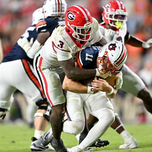 Auburn quarterback Jackson Arnold is sacked by Georgia linebacker CJ Allen during the second half of Saturday's game. Georgia won 20-10. (Hyosub Shin/AJC)