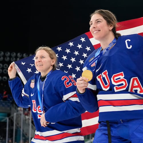 United States' Kendall Coyne, left, and United States' Hilary Knight celebrate after victory ceremony for women's ice hockey at the 2026 Winter Olympics, in Milan, Italy, Thursday, Feb. 19, 2026. (AP Photo/Hassan Ammar)