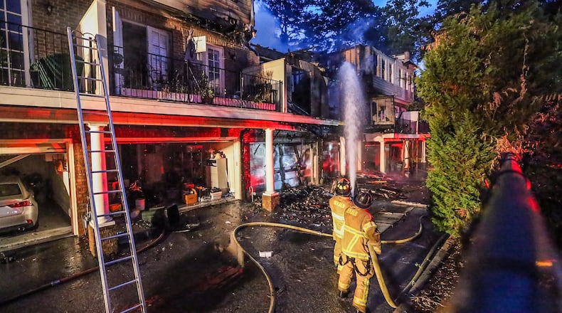 DeKalb County firefighters worked early Thursday to douse a blaze at a Brookhaven townhome complex. JOHN SPINK/JSPINK@AJC.COM