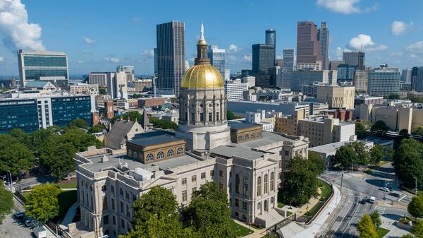FILE - The gold dome of the Georgia State Capitol gleams in the sun in front of the skyline of downtown Atlanta, Ga., Saturday, Aug. 27, 2022. (AP Photo/Steve Helber, File)