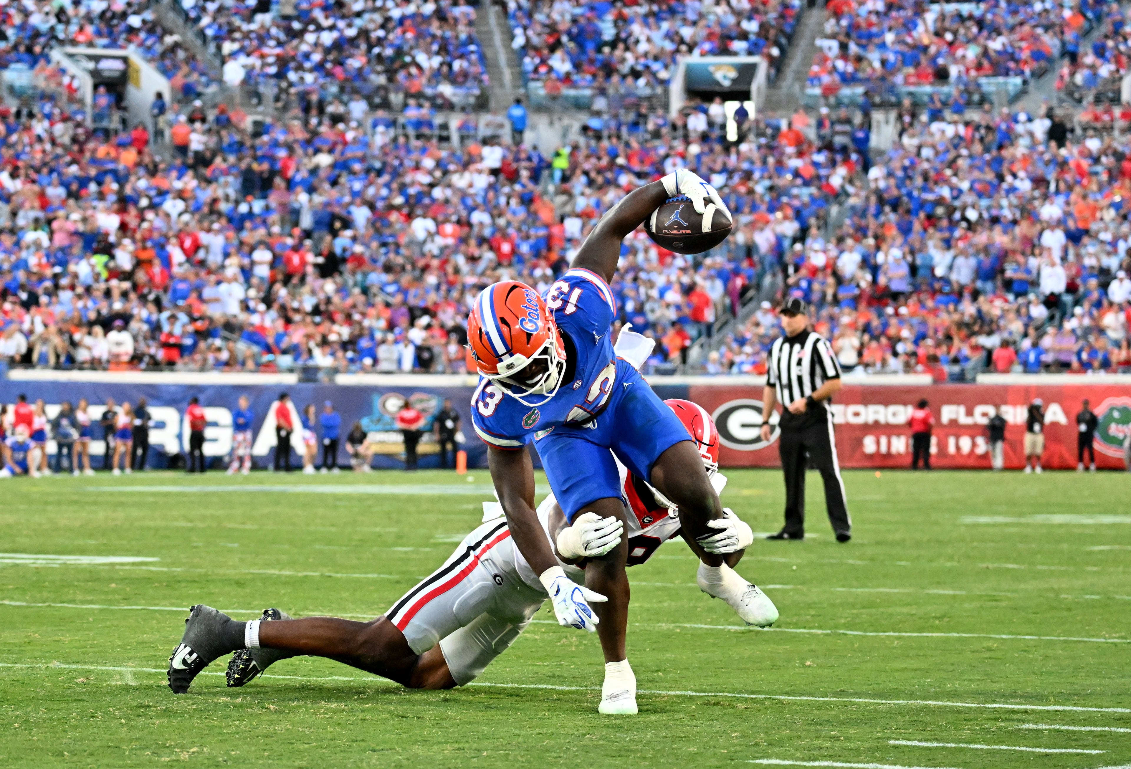Florida running back Jadan Baugh (13) gets tackled by Georgia linebacker Justin Williams (19) during the second half in an NCAA football game, Saturday, November 1, 2025, Jacksonville, Fla. Georgia won 24-20 over Florida. (Hyosub Shin / AJC)