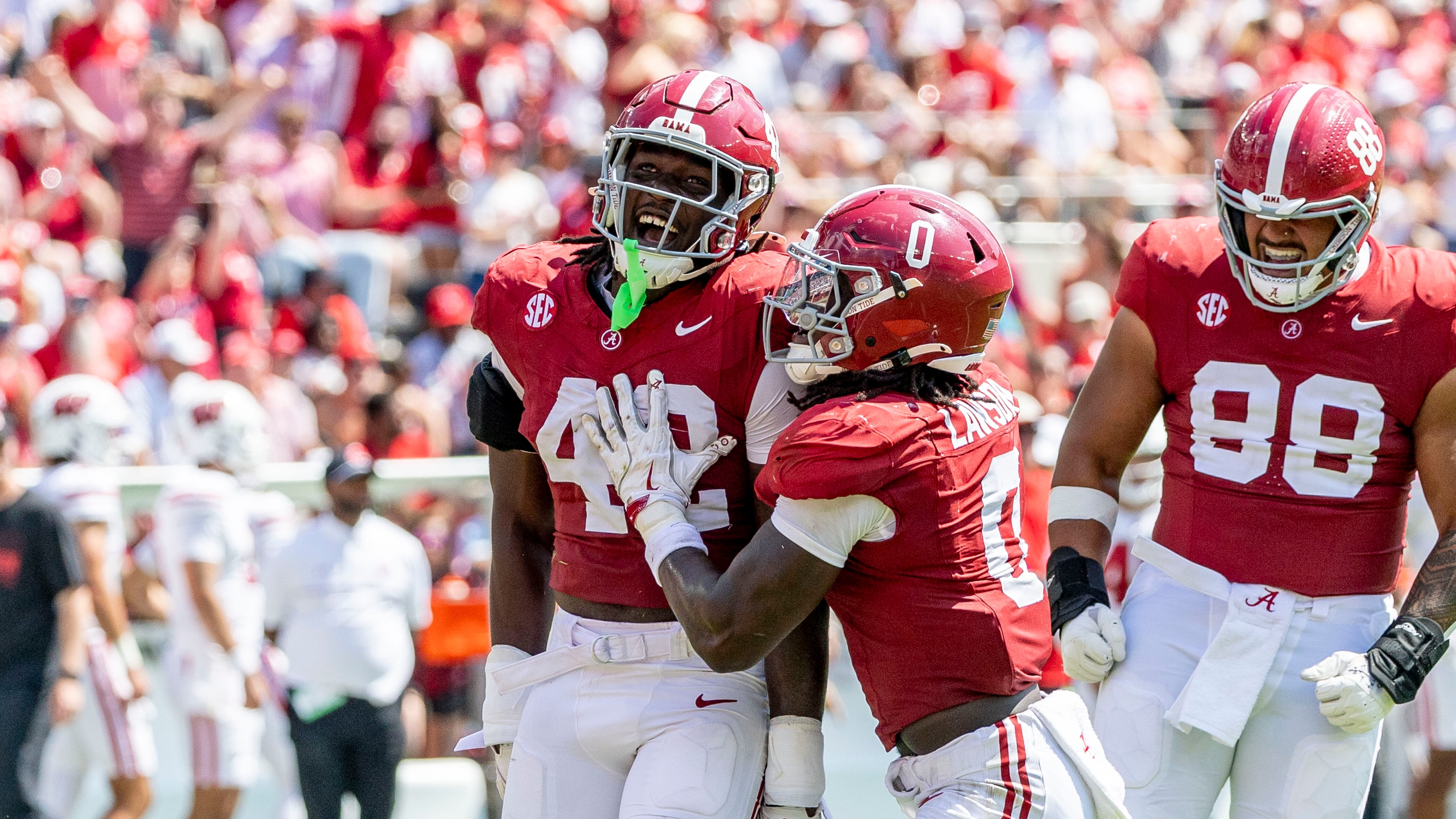 Alabama linebacker Yhonzae Pierre (42) celebrates a sack with Alabama linebacker Deontae Lawson (0) during the second half of an NCAA college football game against Wisconsin, Saturday, Sept. 13, 2025, in Tuscaloosa, Ala. (AP Photo/Vasha Hunt)