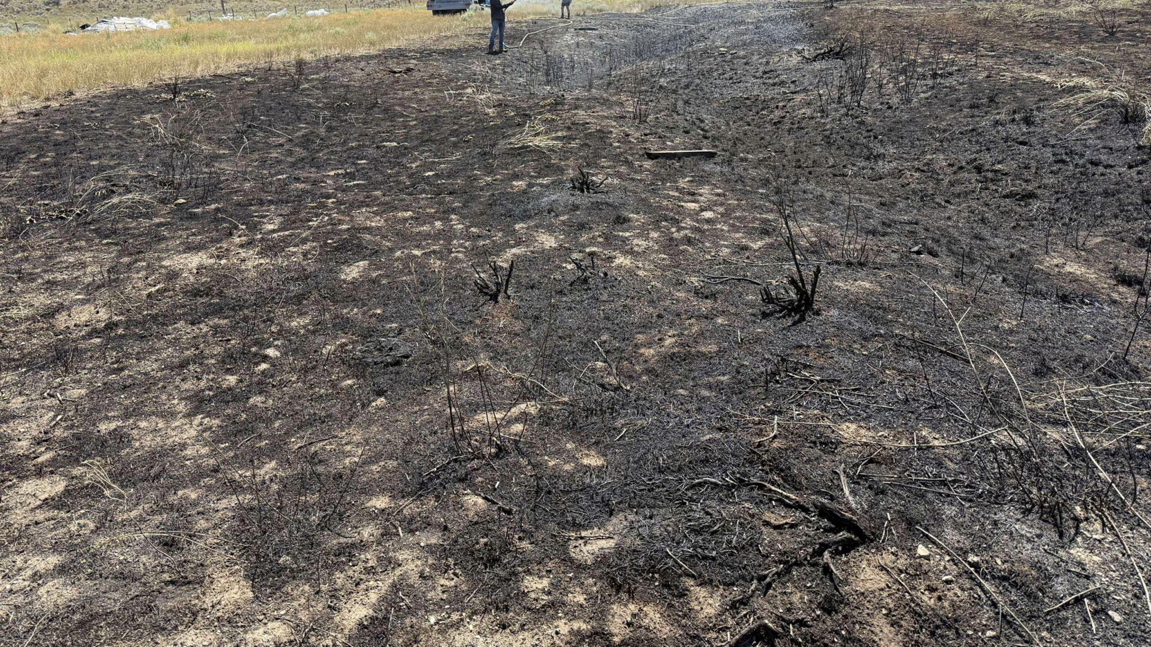This image provided by the Ashcroft Fire Rescue shows people putting out a brush fire south of Ashcroft, British Columbia, on Wednesday, July 30, 2025. (Ashcroft Fire Rescue/Canadian Press via AP)