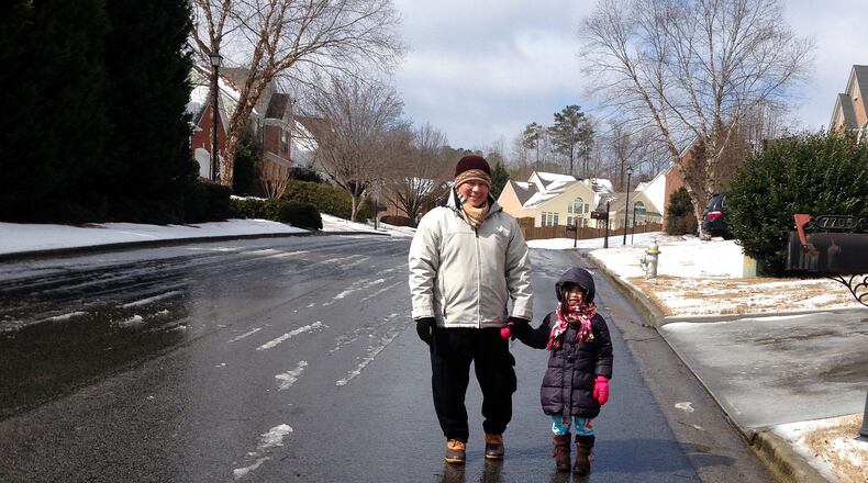 Pete Yau and daughter Kailey, tired of being cooped up in their home, get out for a lunchtime walk Thursday in their Johns Creek neighborhood. Gracie Bonds Staples / gstaples@ajc.com