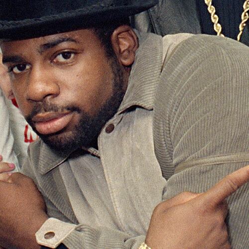 FILE - Run-D.M.C.'s Jason Mizell, Jam-Master Jay, poses with teenagers gathered at New York's Madison Square Garden, Oct. 7, 1986, in New York City. (AP Photo/G. Paul Burnett, File)