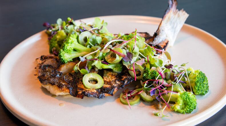 The roasted branzino at Allora is served with broccoli, capers, Castelvetrano olives, lemon and brown butter. CONTRIBUTED BY HENRI HOLLIS