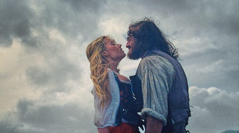 This image released by Warner Bros. Pictures shows Margot Robbie, left, and Jacob Elordi in a scene from "Wuthering Heights." (Warner Bros. Pictures via AP)