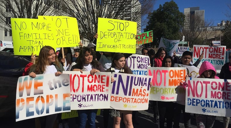 Scores of activists with the Georgia Latino Alliance for Human Rights protested recent arrests outside U.S. Immigration and Customs Enforcement’s downtown Atlanta offices Thursday. JEREMY REDMON/jredmon@ajc.com