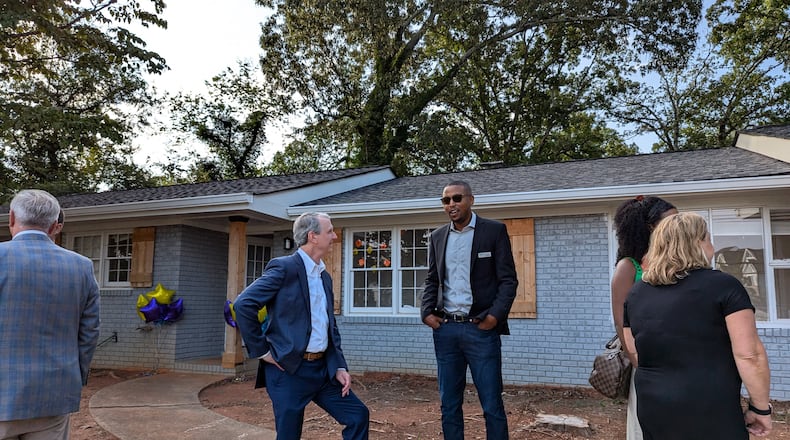 Family Promise board members Coye Mann (left) and Juron Dobbs tour the Roswell house recently donated to the nonprofit. Courtesy