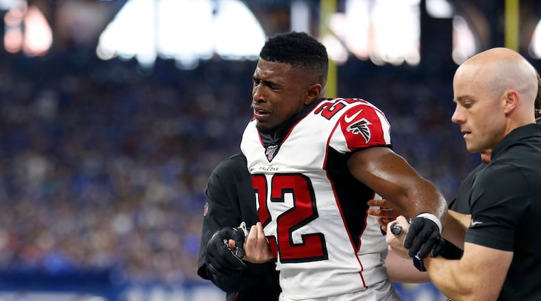 Falcons safety Keanu Neal is helped off the field after suffering his second-quarter Achilles injury Sunday. (Photo by Justin Casterline/Getty Images)