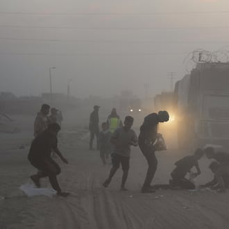 Palestinians rush toward trucks carrying aid from the World Food Programme (WFP) as they drive through Deir al-Balah in central Gaza, Saturday, Nov. 8, 2025. (AP Photo/Abdel Kareem Hana)