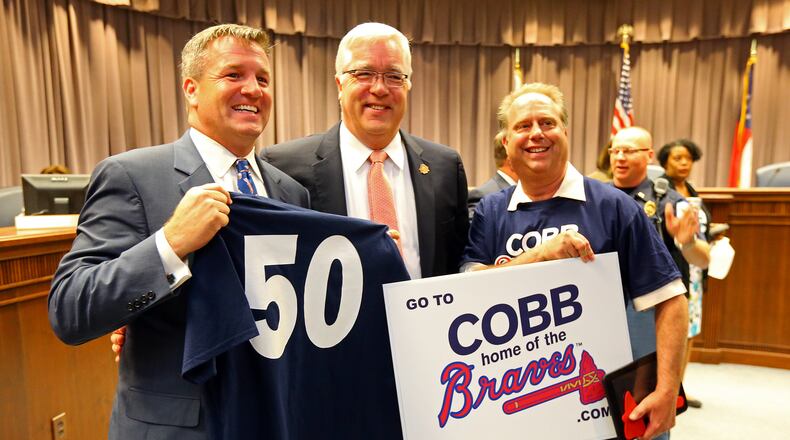 Cobb County Chairman Tim Lee poses with Braves supporters in May 2014. Lee was defeated in his re-election bid last week. Curtis Compton, ccompton@ajc.com
