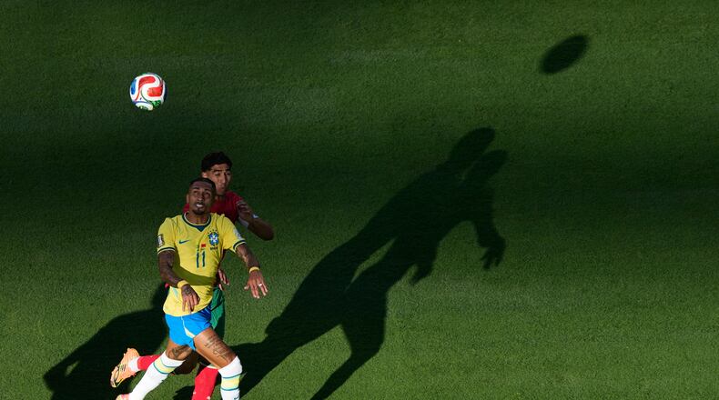 Brazil's Raphinha (11) and Morocco's Achraf Hakimi go up for a head ball during the World Cup Group C soccer match in East Rutherford, N.J., near New York, Saturday, June 13, 2026. (AP Photo/Matt Slocum)